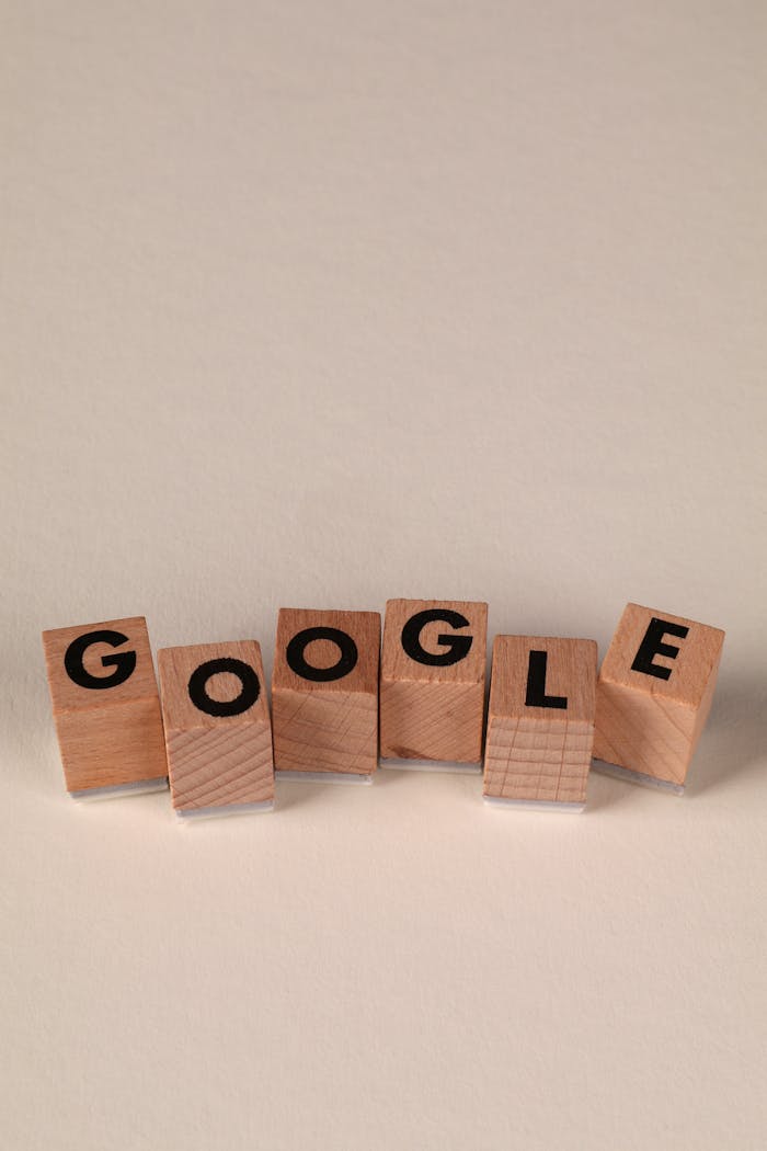 Wooden alphabet blocks forming the word Google on a plain background, arranged playfully.